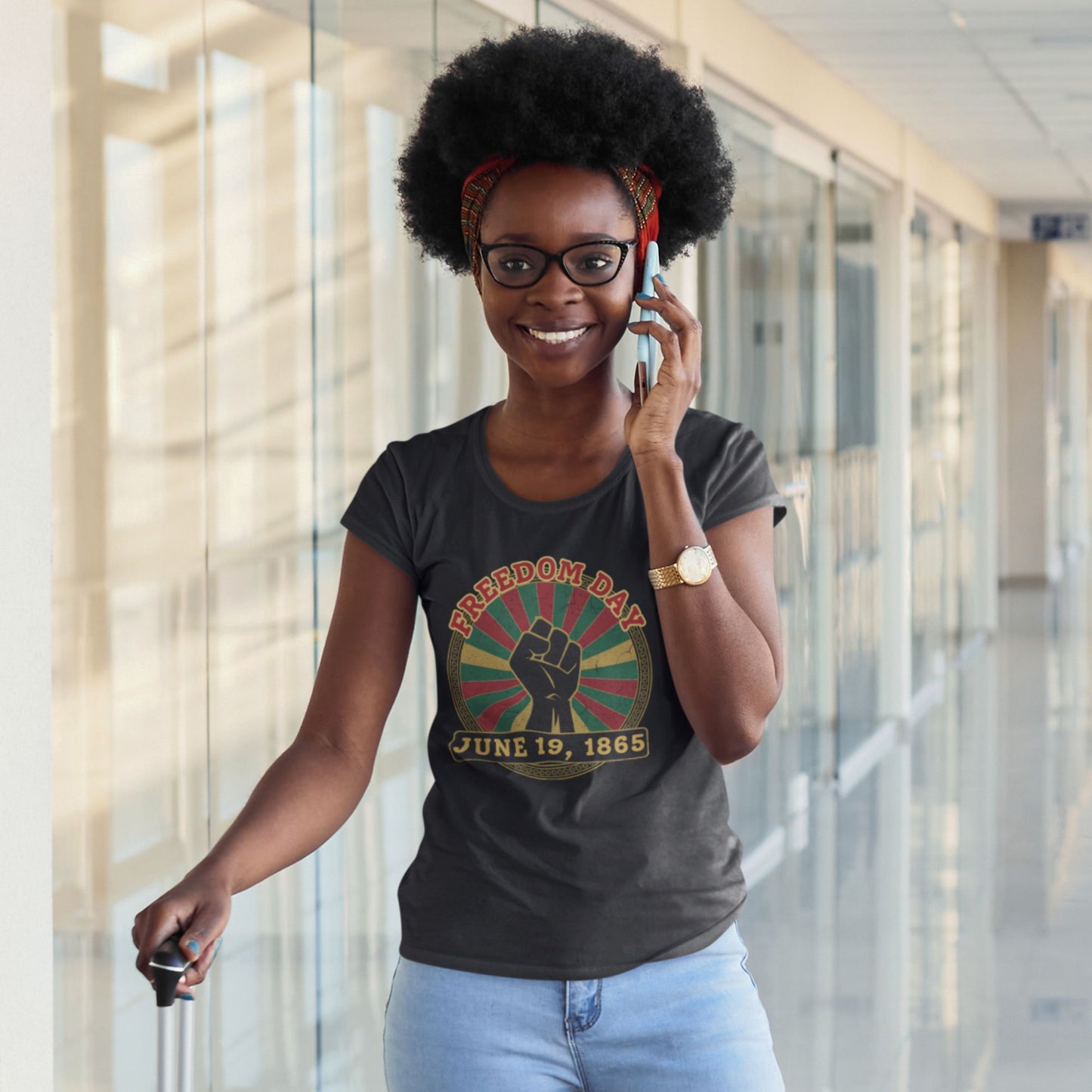 Freedom Day Juneteenth Graphic Tee in Black – Black woman wearing June 19 1865 raised fist Pan-African tee

