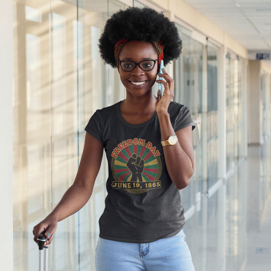 Freedom Day Juneteenth Graphic Tee in Black – Black woman wearing June 19 1865 raised fist Pan-African tee

