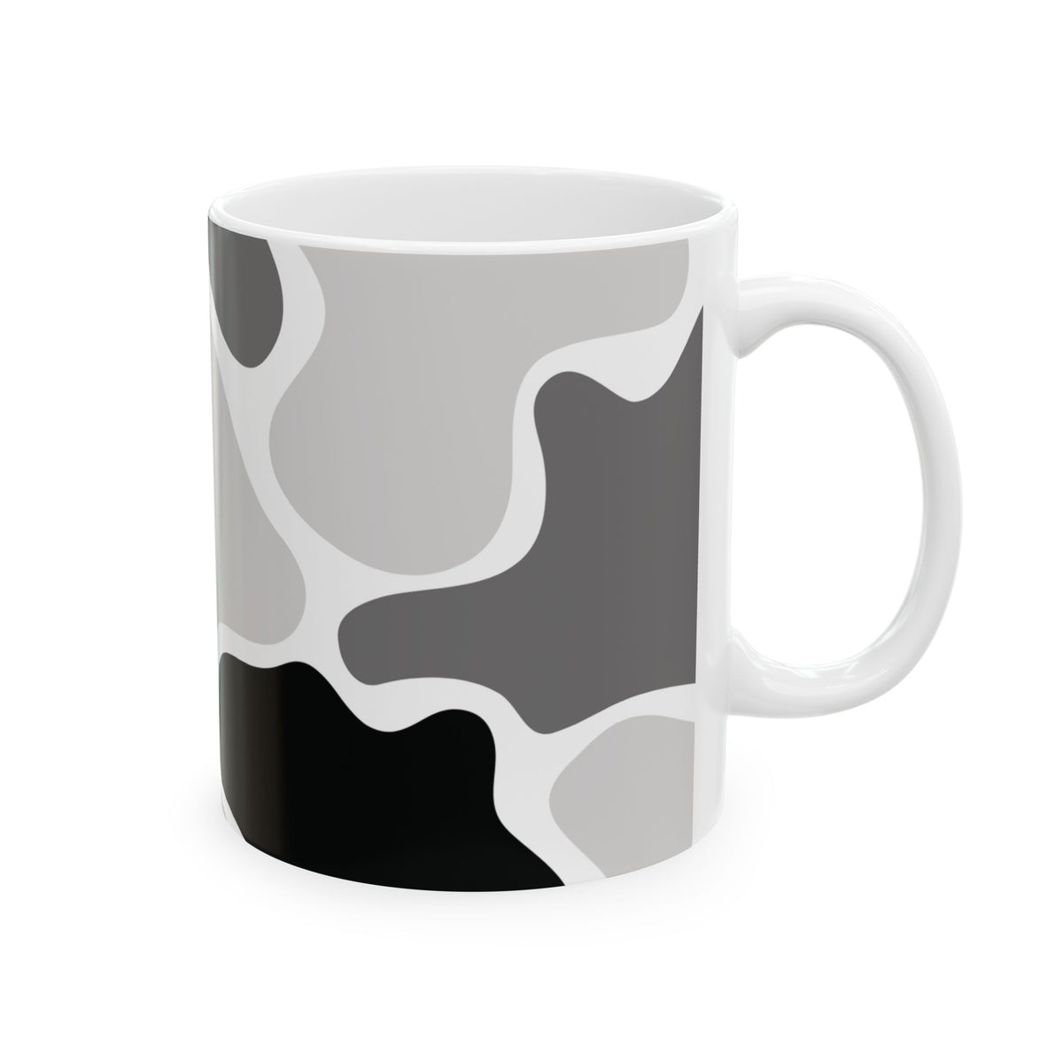 White mug with handle on the right, showing gray abstract shapes and a black patch along the bottom.