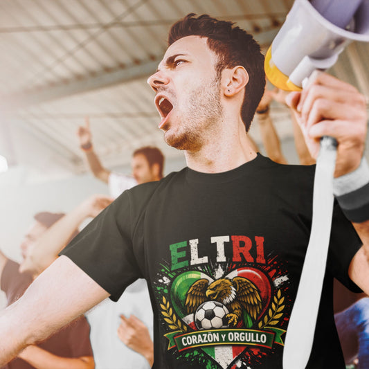 Man holding a megaphone with 'EL TRI' t-shirt featuring an eagle and soccer ball design.