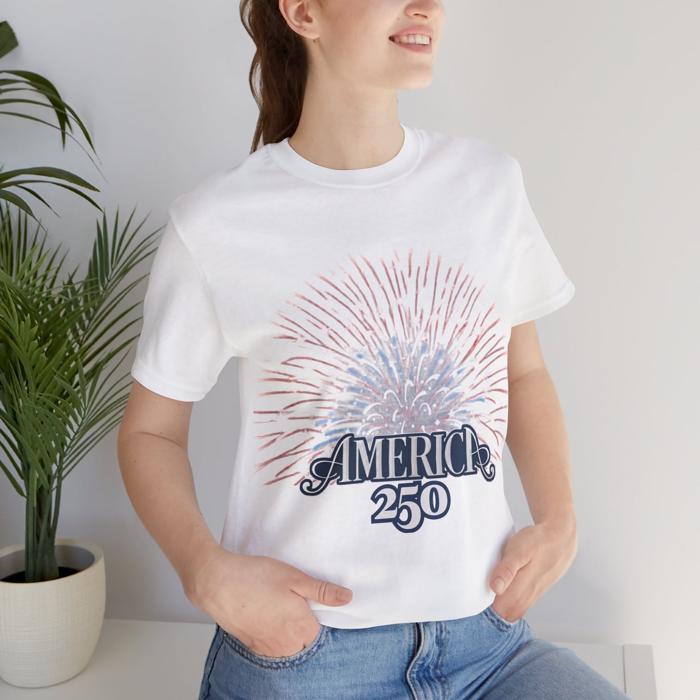 America 250 Fireworks Graphic Tee in White – woman wearing patriotic America 250 fireworks sunburst tee indoors

