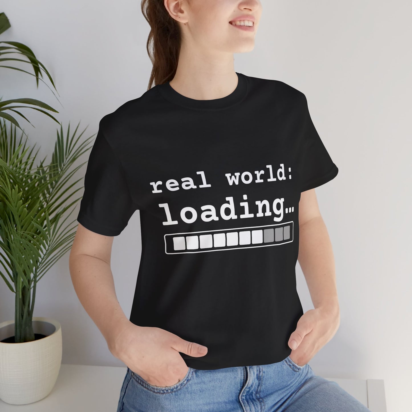 Woman wearing Black real world loading graphic tee indoors — senior picture outfit idea streetwear style