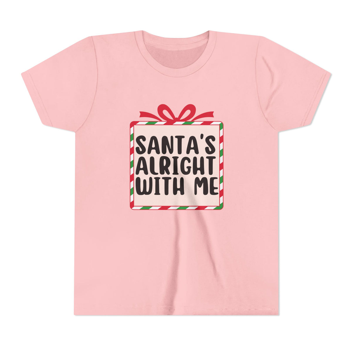 A light pink short-sleeve crewneck t-shirt featuring a graphic of a wrapped gift box with a red ribbon and the text 'SANTA'S ALRIGHT WITH ME' in black lettering.