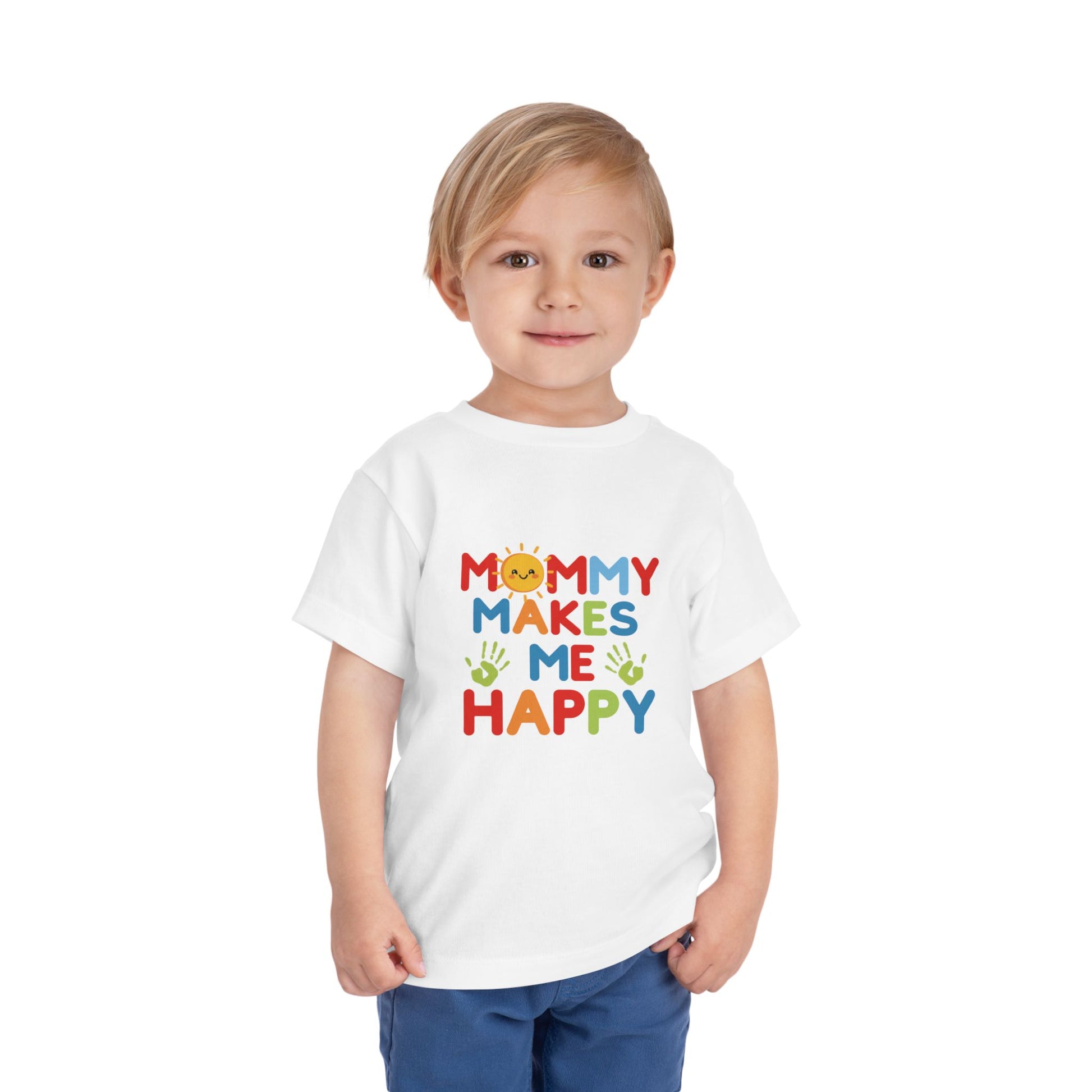 Toddler boy wearing white Mommy Makes Me Happy rainbow graphic tee standing outdoors
