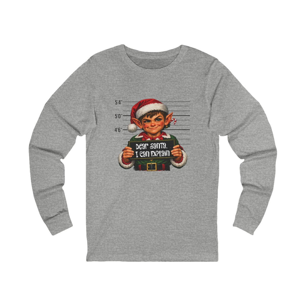 A heather gray long-sleeve t-shirt featuring a graphic print of a mugshot-style portrait of an elf holding a sign that reads 'DEAR SANTA, I CAN EXPLAIN'.