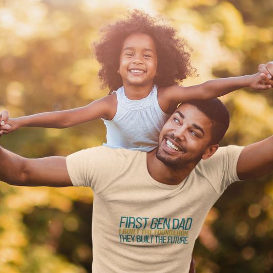 Dad wearing First Gen Dad I Built The Foundation They Built The Future soft cream tee with daughter on shoulders