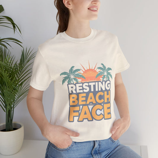 Woman wearing peach Resting Beach Face graphic tee indoors — Leela's Ink streetwear

