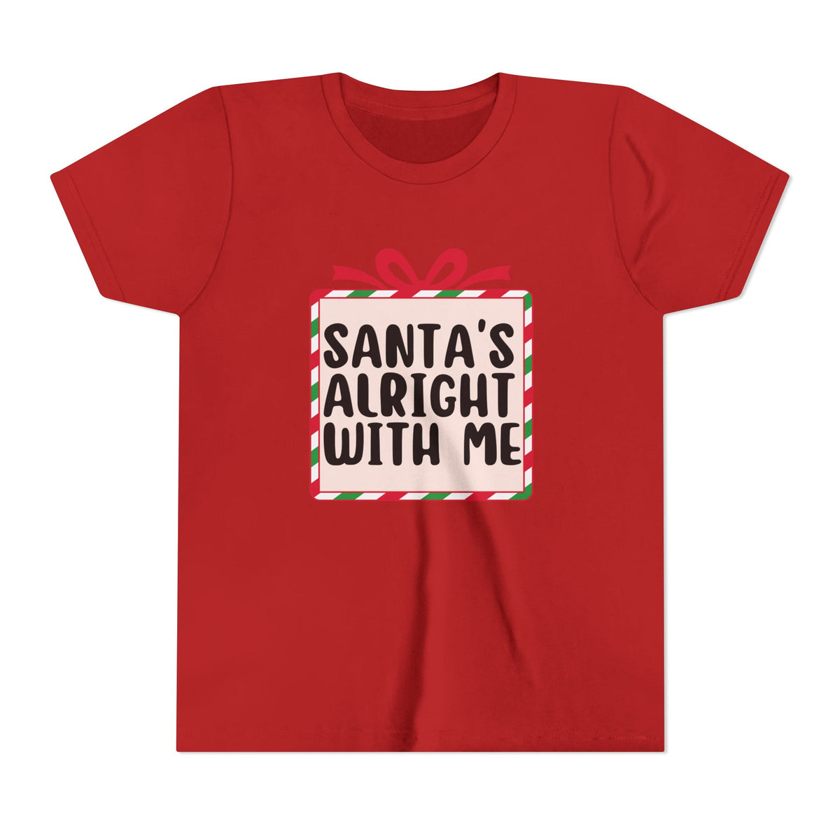 A red short-sleeve crewneck t-shirt featuring a graphic of a gift box with the text 'SANTA'S ALRIGHT WITH ME' in black letters, decorated with a red bow and green and white striped border.