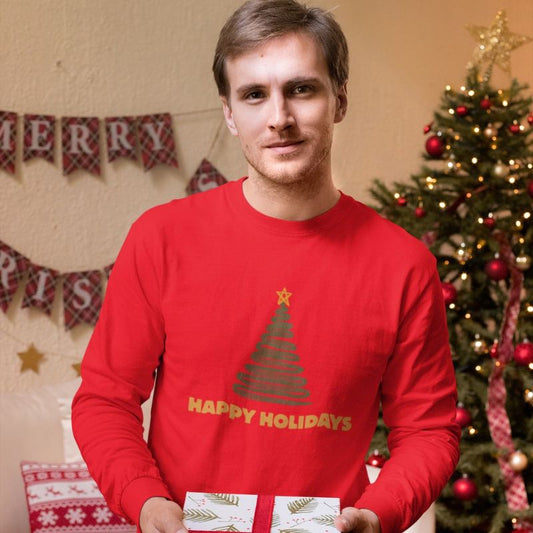 Model wearing the red “Happy Holidays” long-sleeve shirt in a Christmas-decorated room.