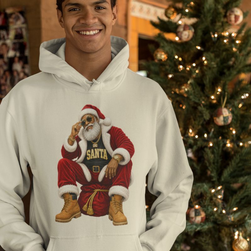 Man modeling a white OG Santa Christmas hoodie beside a decorated Christmas tree.