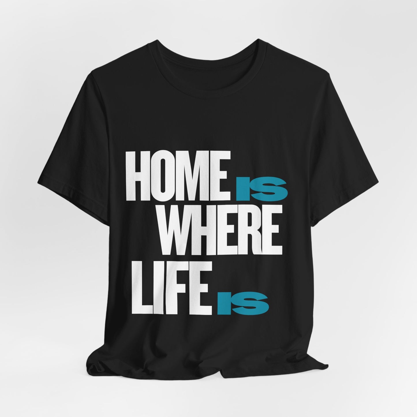Home Is Where Life Is graphic t-shirt in black by Leela's Ink, unisex adult tee with bold white and teal typography, lifestyle mockup front view