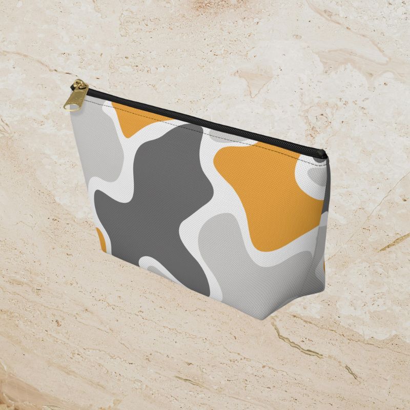 Angled view of the camouflage pouch showing its side profile and zipper.