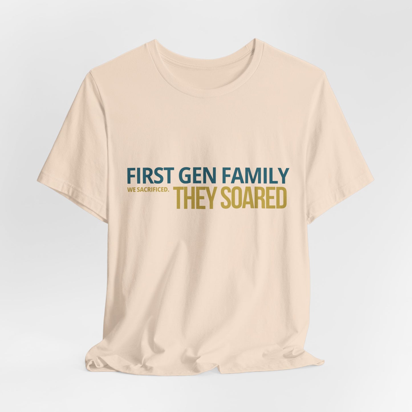 First Gen Family They Soared tee in soft cream close-up — bold teal and gold typography detail — graduation gift for first gen families