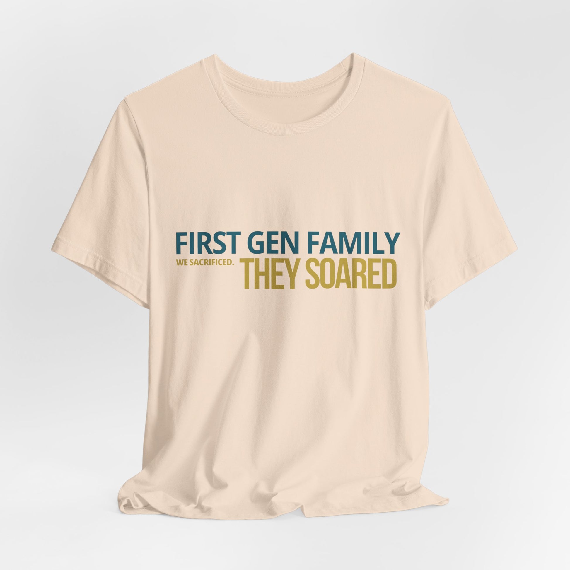 First Gen Family They Soared tee in soft cream close-up — bold teal and gold typography detail — graduation gift for first gen families