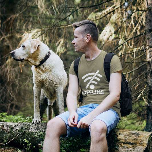 Man and golden retriever dog outdoors wearing OFFLINE crossed-out WiFi graphic tee — funny travel shirt
