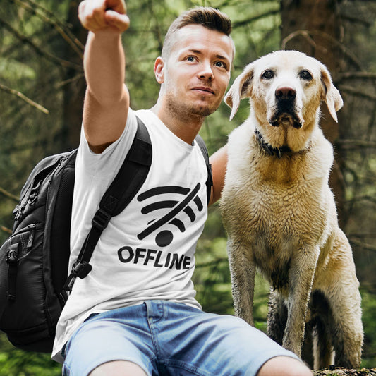 Man wearing white OFFLINE graphic tee pointing in forest with golden retriever dog — digital detox t-shirt
