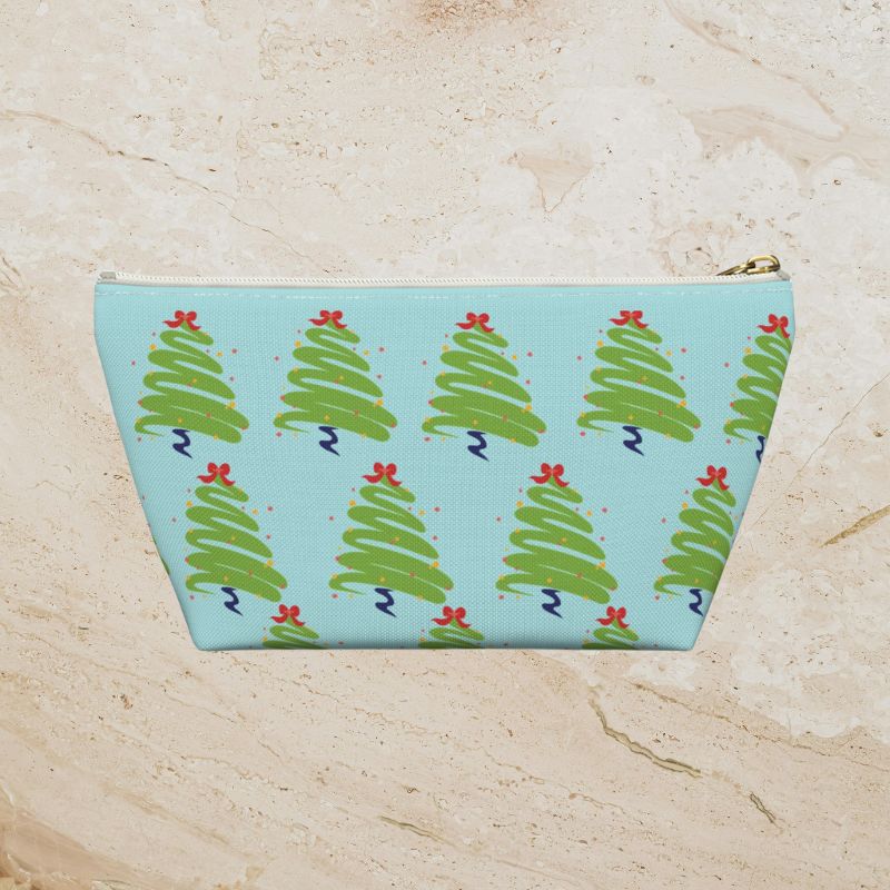 Back view of the icy-blue pouch showing its green Christmas tree print.
