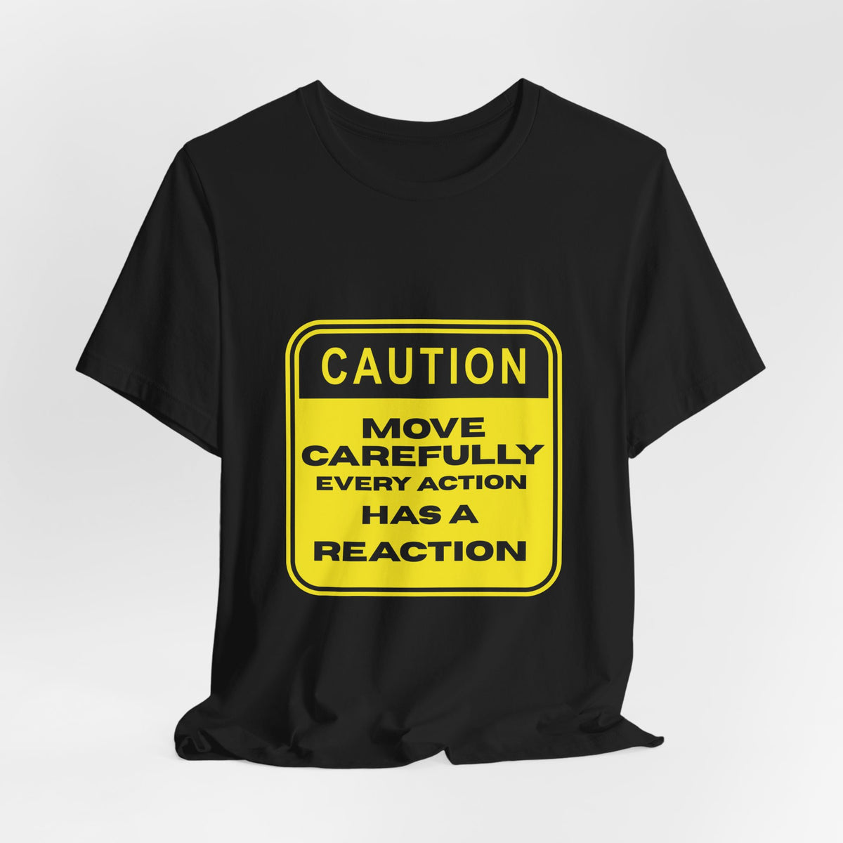Black graphic t-shirt with a yellow Caution Move Carefully Every Action Has a Reaction sign design