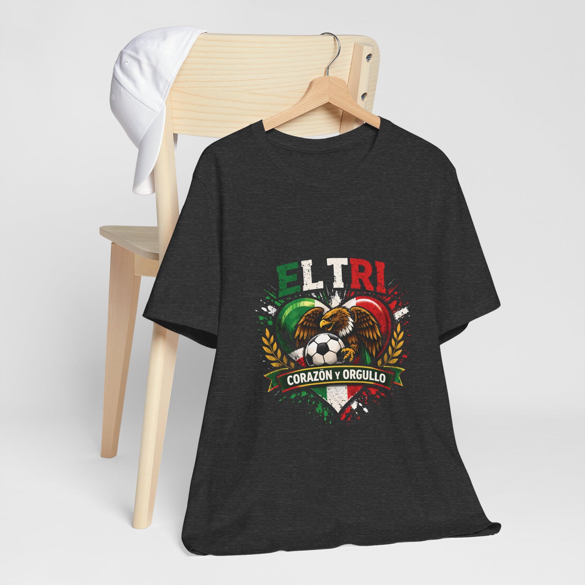 heather black El Tri Corazón y Orgullo tee on hanger, front view

