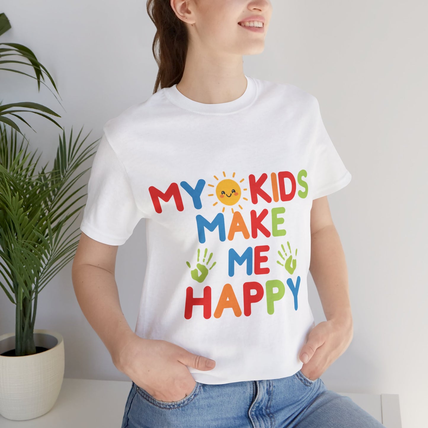 Woman wearing white My Kids Make Me Happy rainbow smiley sun graphic tee 