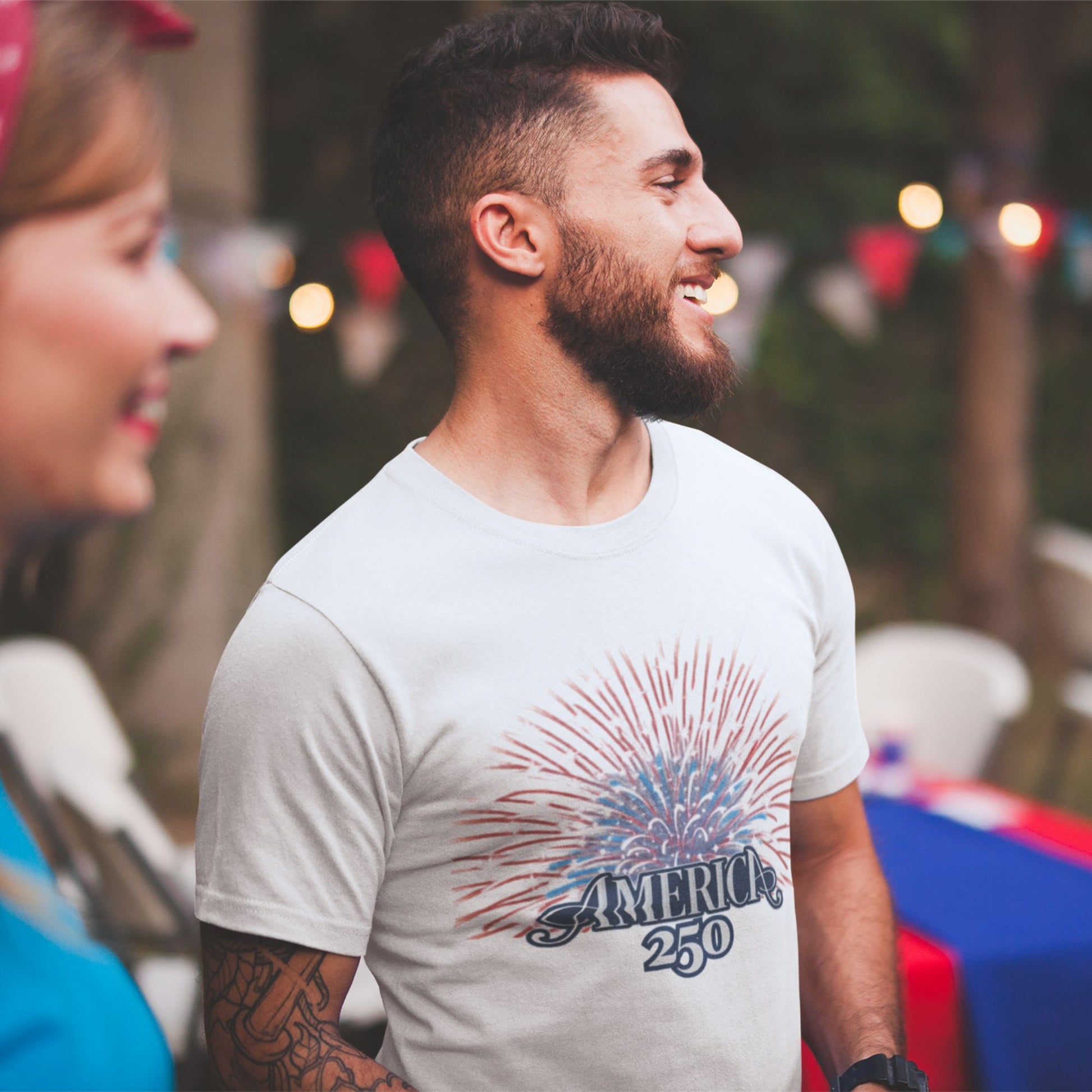 America 250 Fireworks Graphic Tee in Athletic Heather – man and woman at 4th of July celebration wearing patriotic USA 250th anniversary shirt

