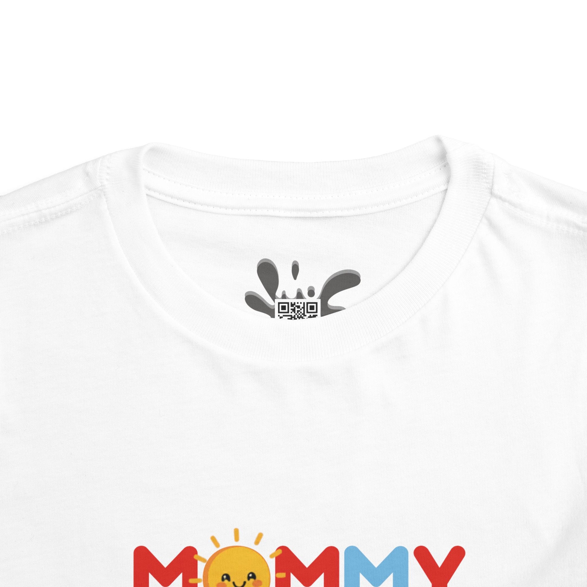 White t-shirt with colorful 'Mommy' design and black paw print logo on a white background