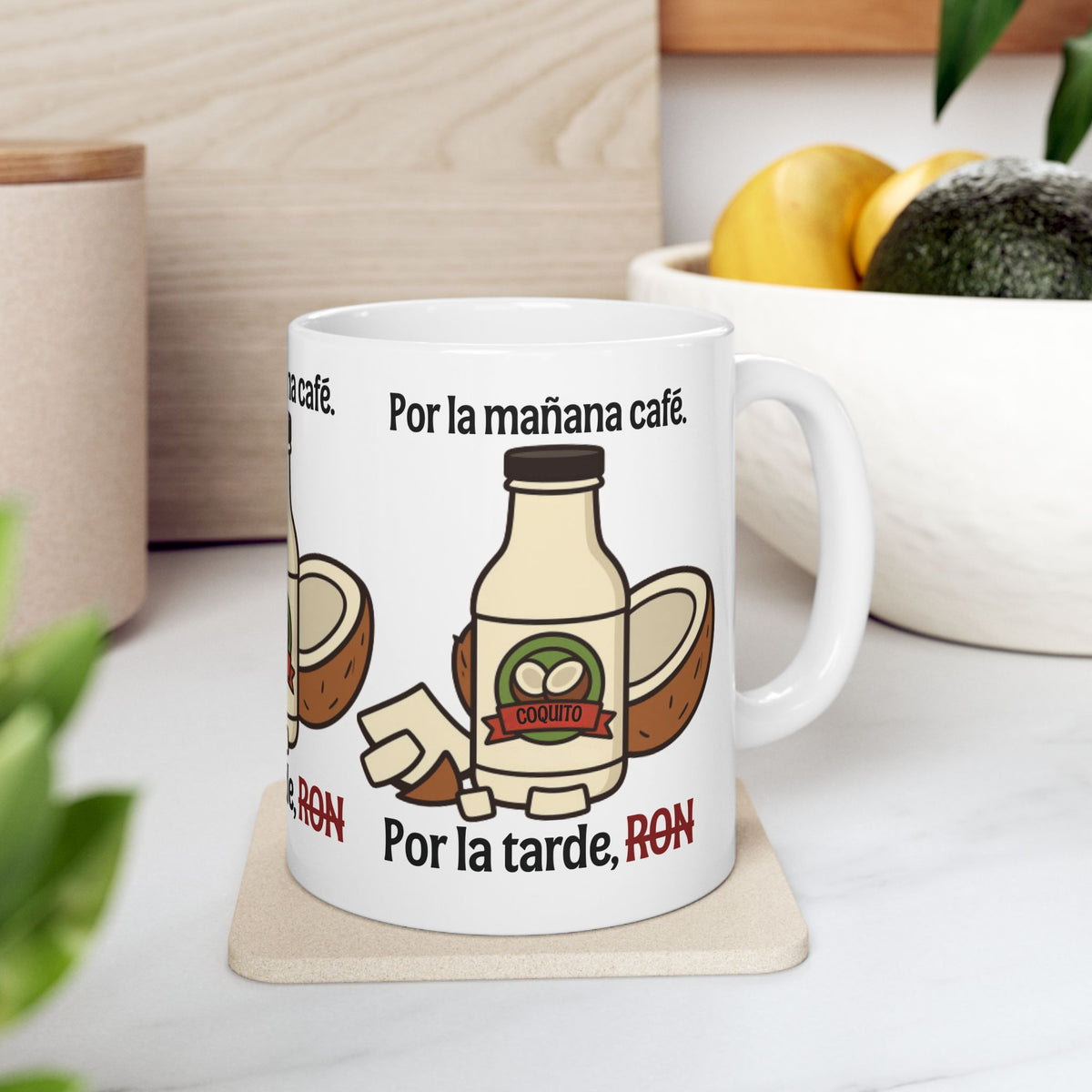 White mug on a kitchen counter with a rum bottle illustration and “Por la mañana café. Por la tarde, RON.