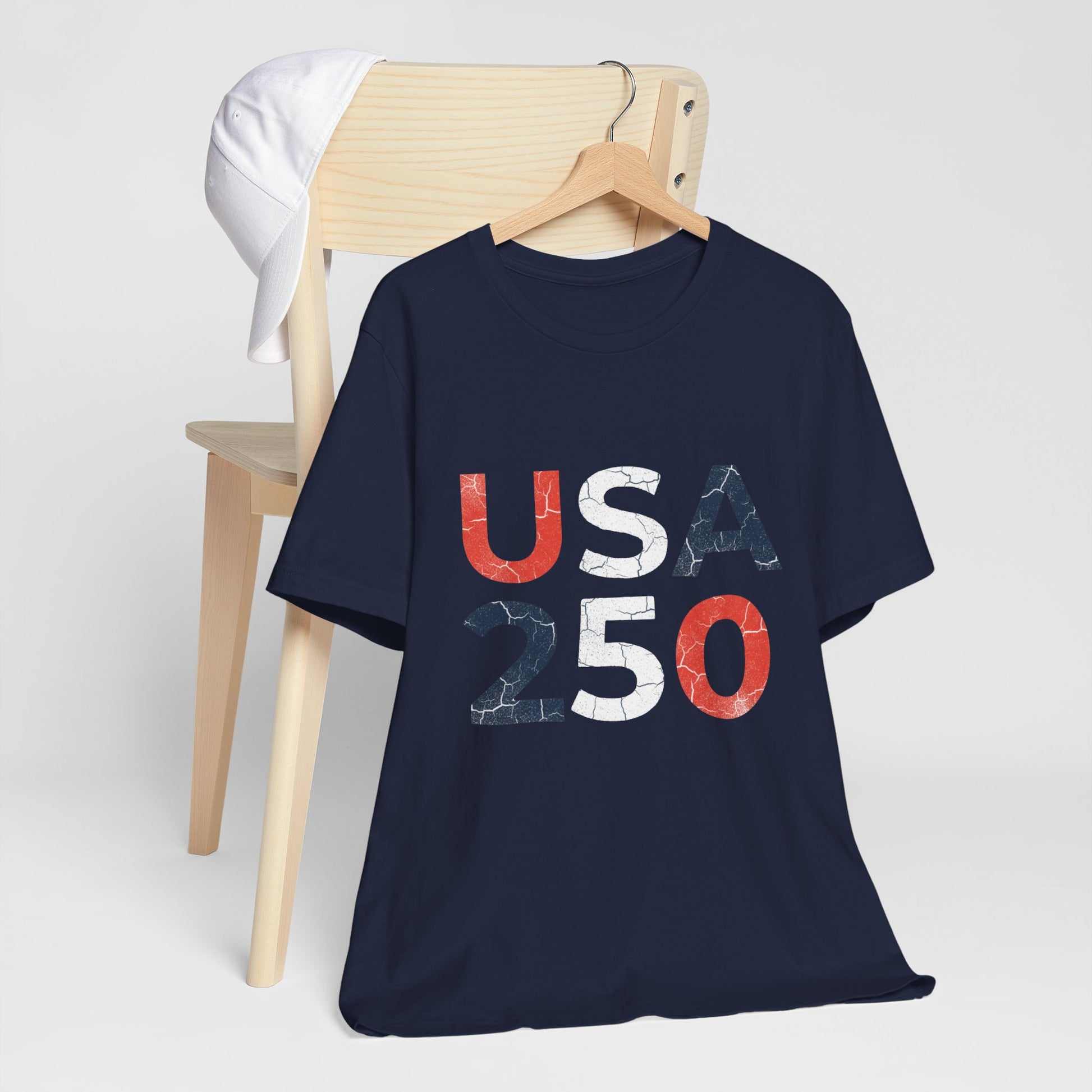 USA 250 Distressed Graphic Tee in Navy – hanger mockup showing bold distressed USA 250 patriotic block letter design

