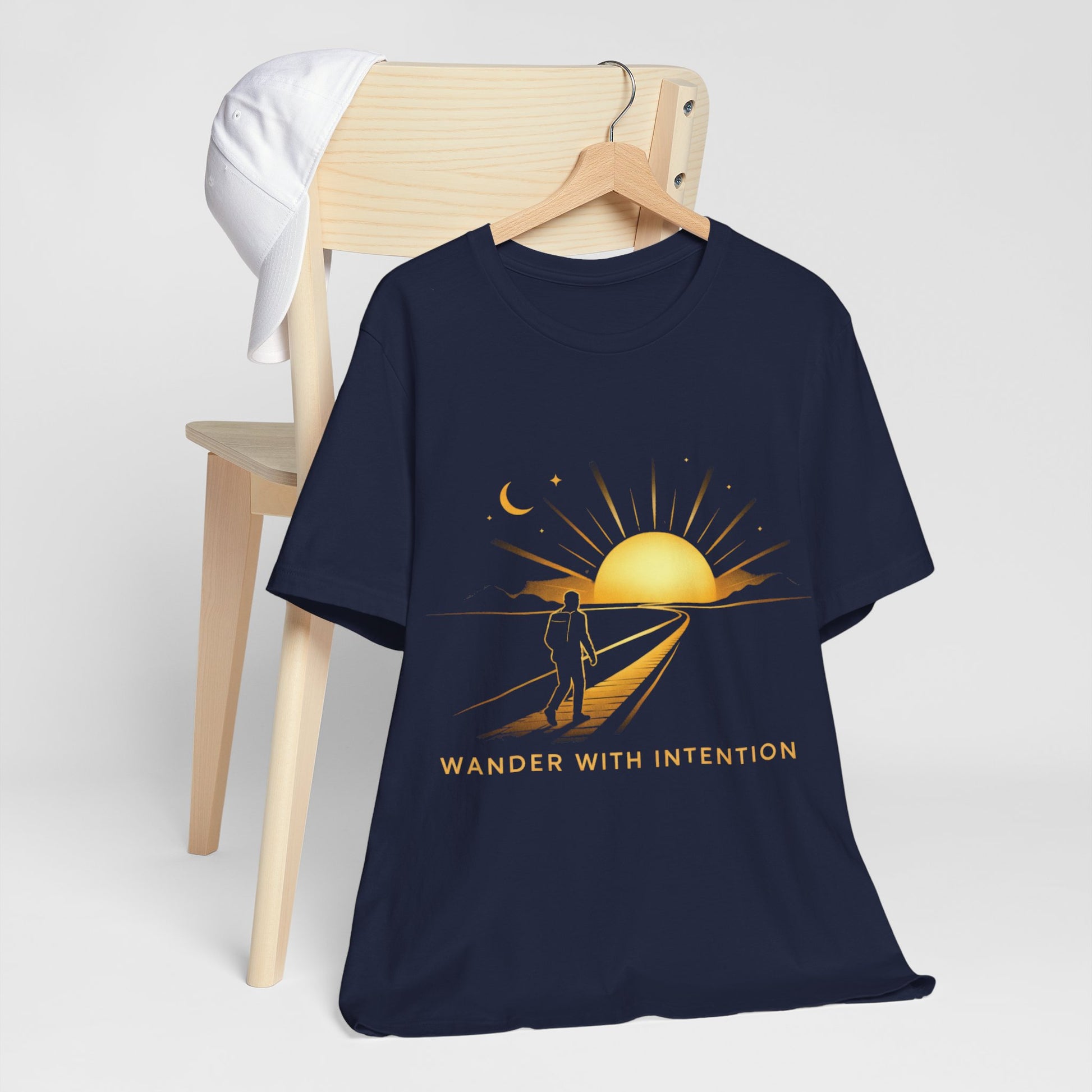 Navy Wander With Intention tee on hanger, front view with sunset and surfer graphic
