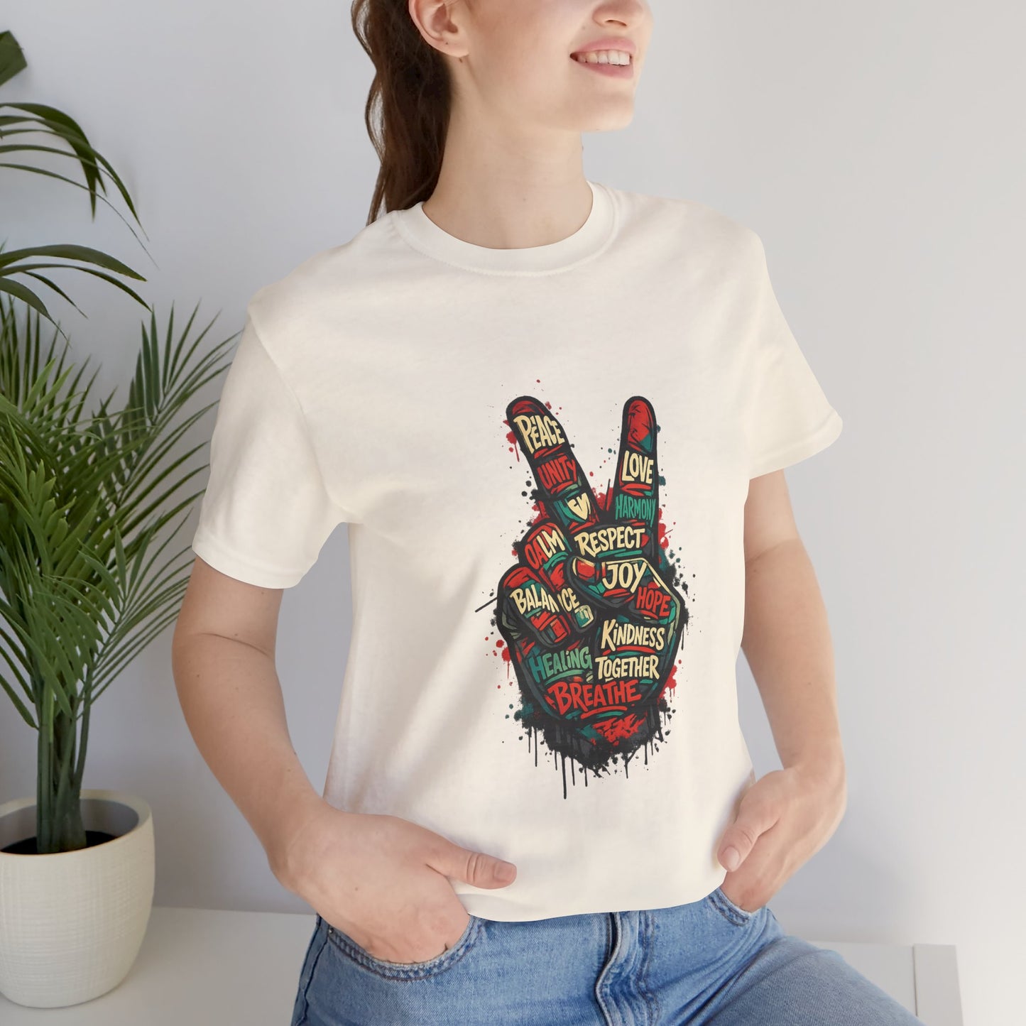 Woman wearing white Adult Peace Sign graphic t-shirt with bold positive words, outdoor lifestyle shot
