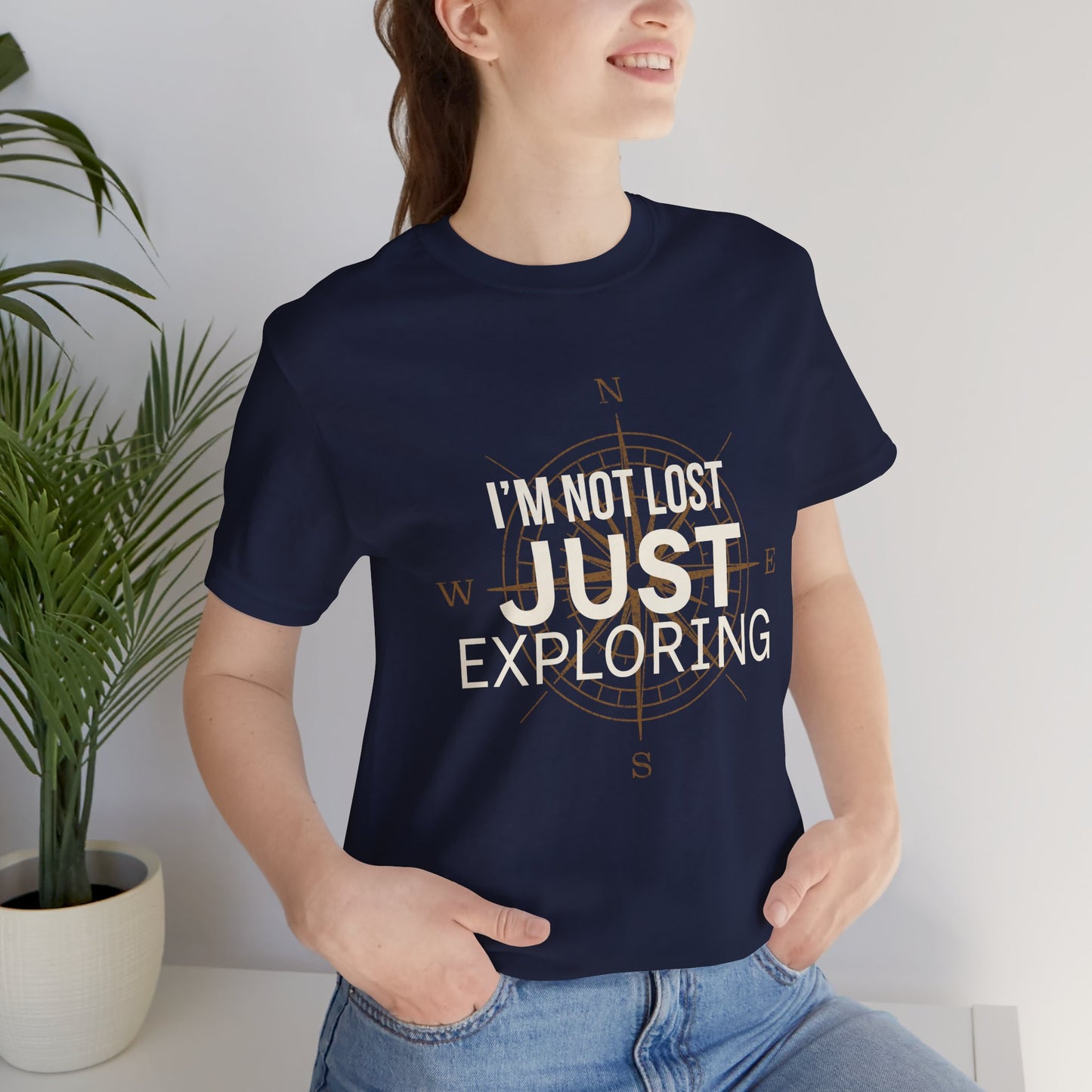 Unisex navy graphic tee with vintage compass rose and bold text 'I'm Not Lost Just Exploring' — relaxed fit travel t-shirt
