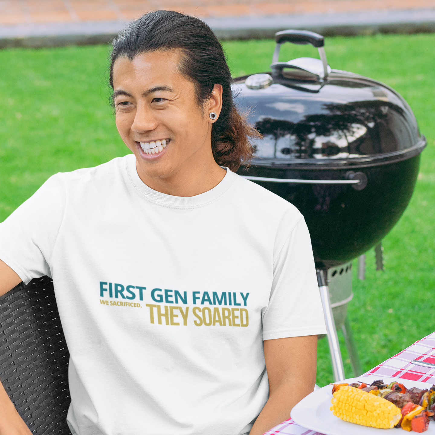 Man wearing First Gen Family They Soared graduation tee in white at backyard BBQ — urban streetwear grad party shirt for first gen families