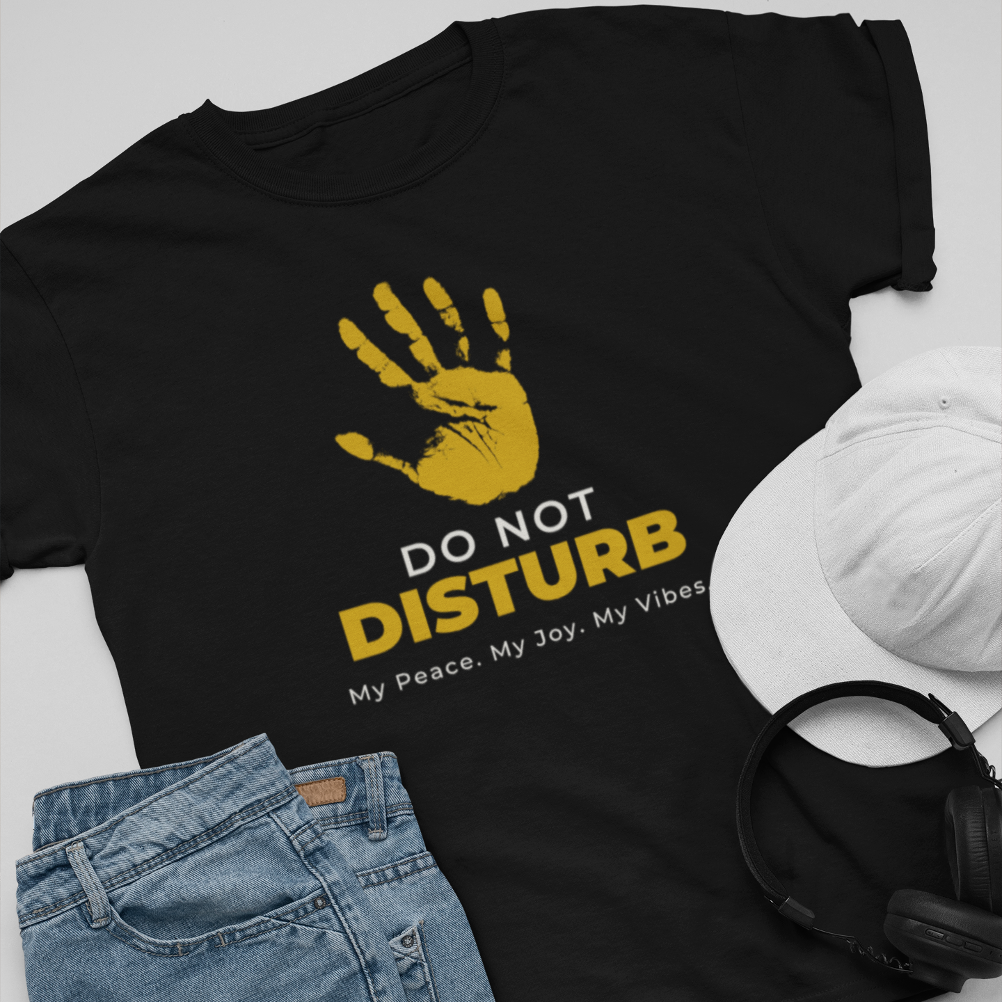  Do Not Disturb graphic tee flat lay — bold yellow hand print streetwear tee styled with denim