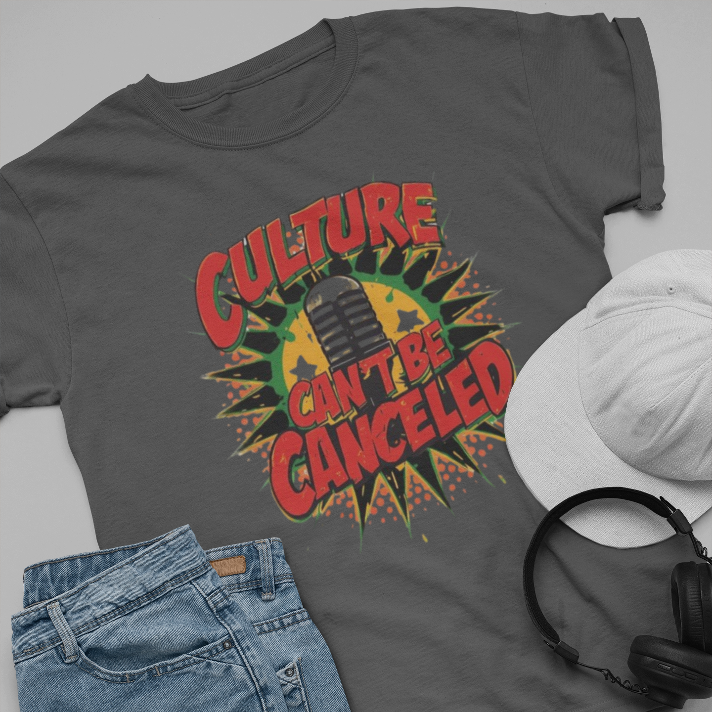 Gray t-shirt with 'Culture Can't Be Cancelled' design, paired with jeans, sneakers, and a skateboard on a light gray background.