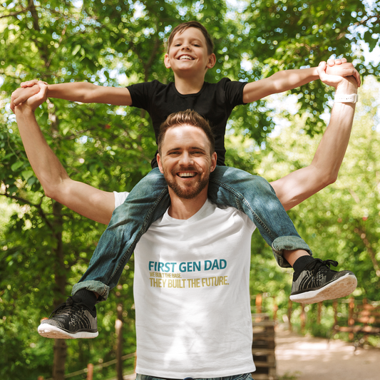 First Gen Dad graduation tee in white — dad holding child on shoulders in park — streetwear graduation gift for first gen dads