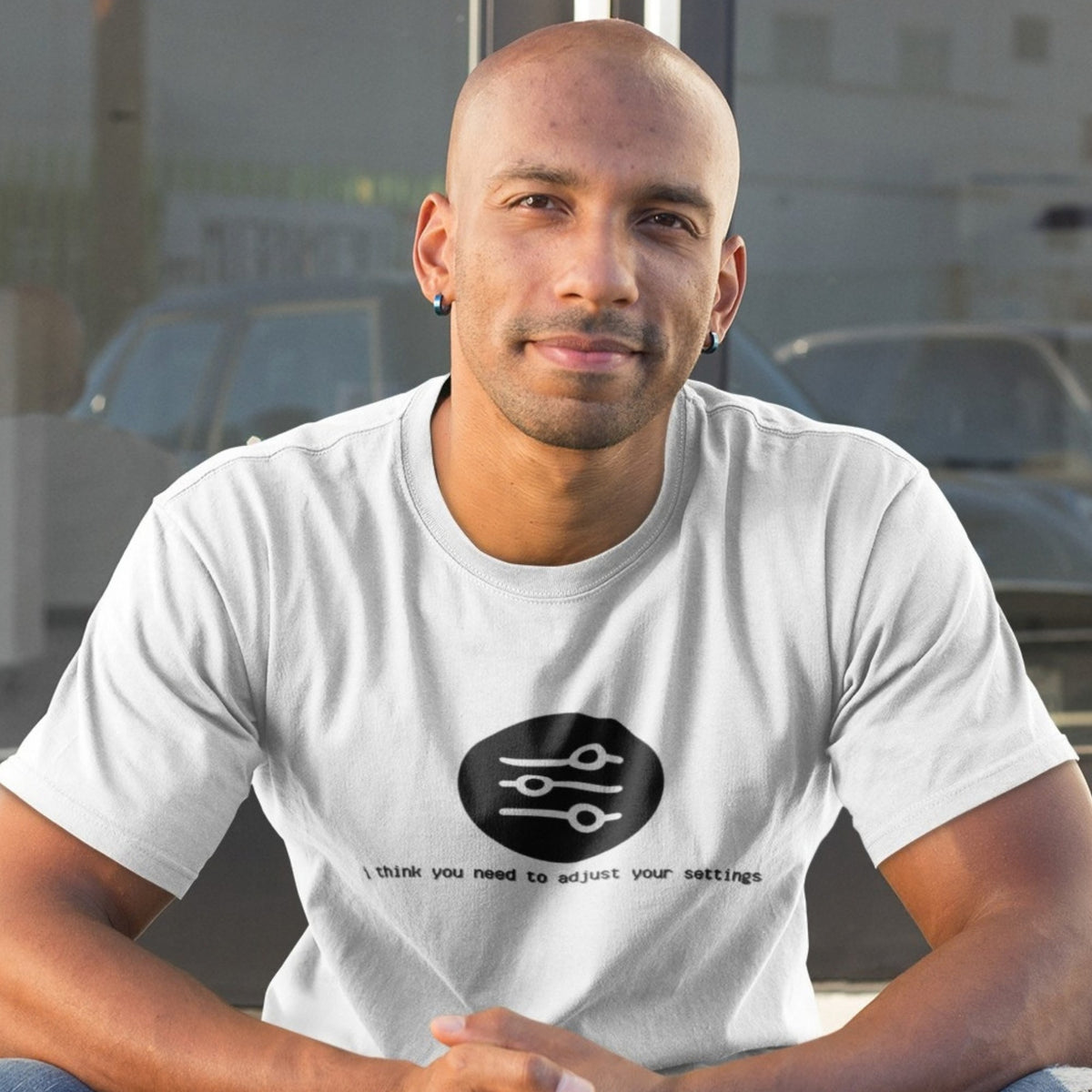 Man wearing a white I Think You Need to Adjust Your Settings graphic t-shirt, relaxed everyday look