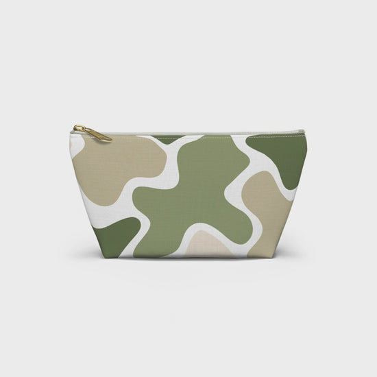 Product slideshow of a sage green and beige abstract camo accessory pouch with a white zipper and gold-tone pull, displayed against a white background.
