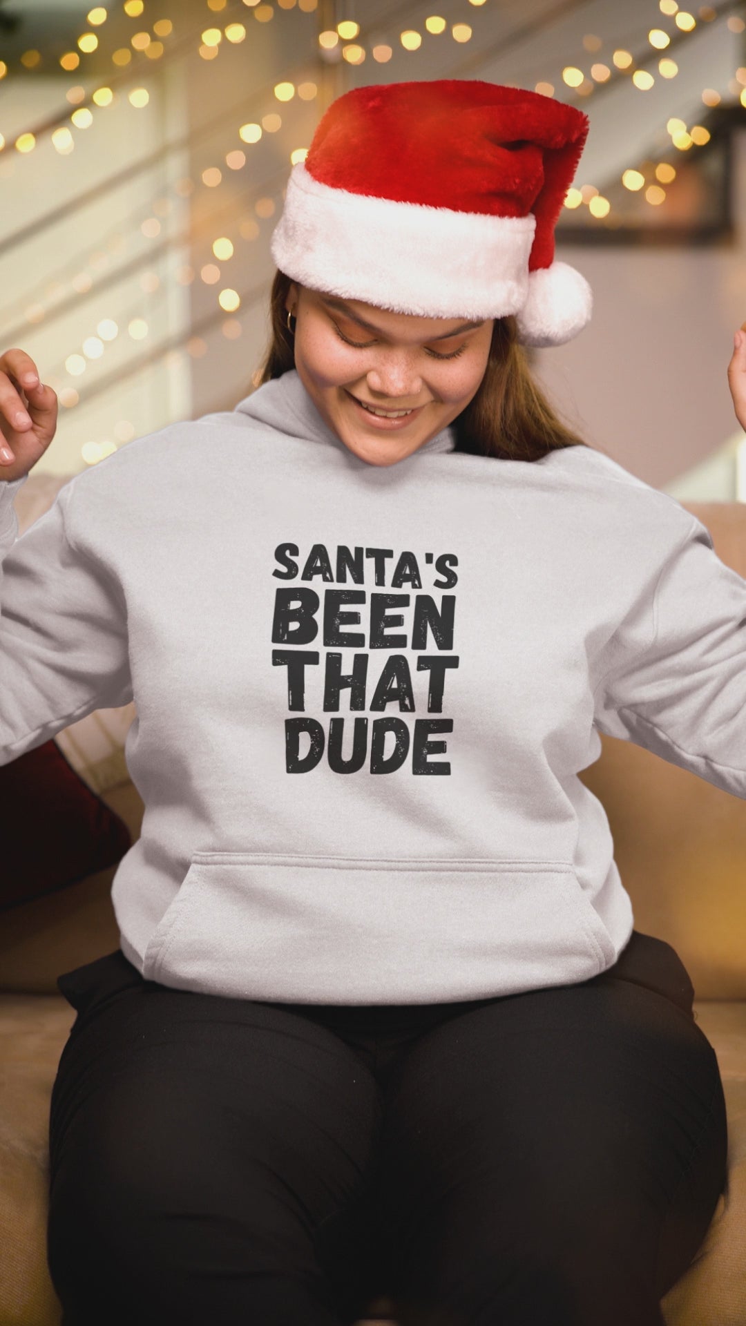 Video preview of a person wearing a white “Santa’s Been That Dude” hoodie.