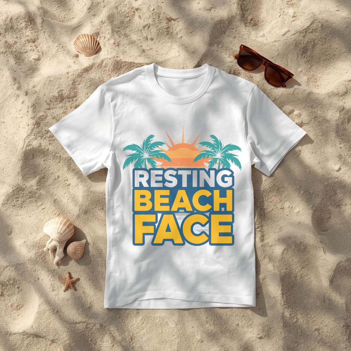 Resting Beach Face white graphic tee flat lay on sand with sunglasses — Leela's Ink

