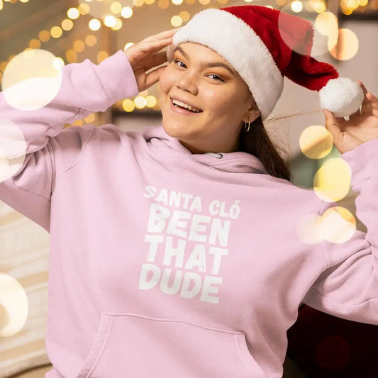 Woman in a Santa hat wearing a light pink Santa Cló Been That Dude hoodie