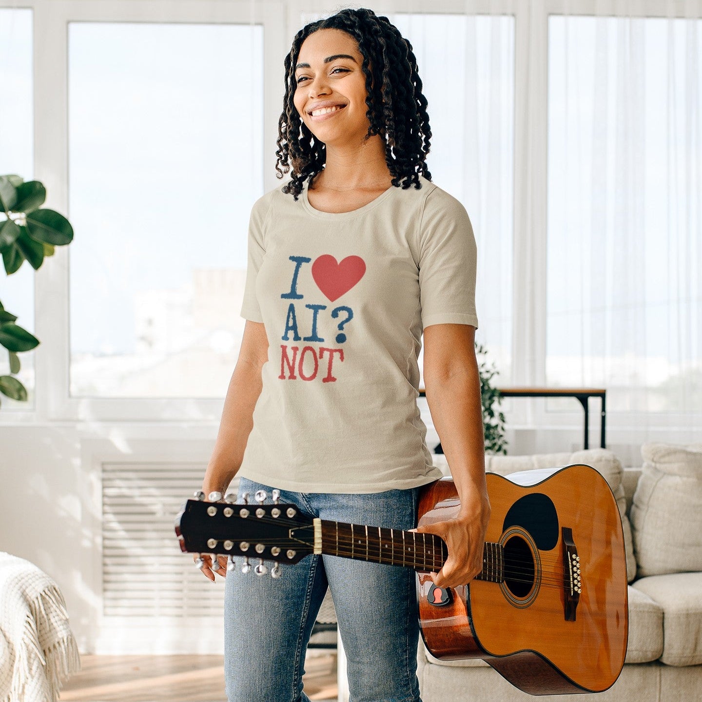 A woman stands in a bright living room holding an acoustic guitar, wearing a graphic t-shirt that reads 'I [heart] AI? NOT' in blue and red text on a light beige background.