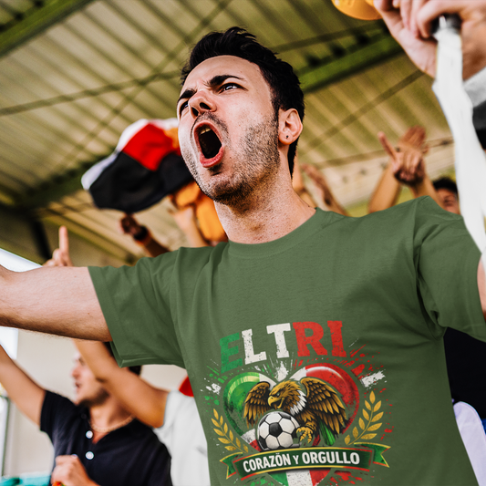 Man celebrating at stadium in military green El Tri Corazón y Orgullo tee, crowd energy lifestyle shot
