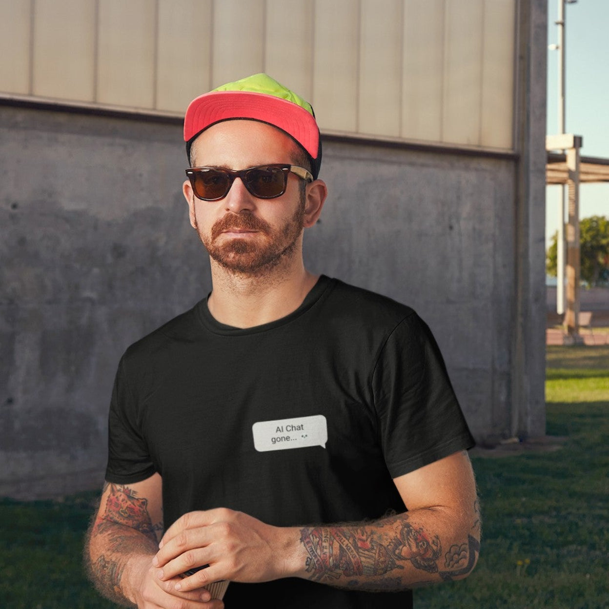 Man in snapback wearing Help Me Be Normal graphic tee in black with left chest chat bubble print
