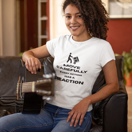 Smiling woman with curly hair holding a guitar, wearing a white Move Carefully Every Action Has a Reaction graphic t-shirt