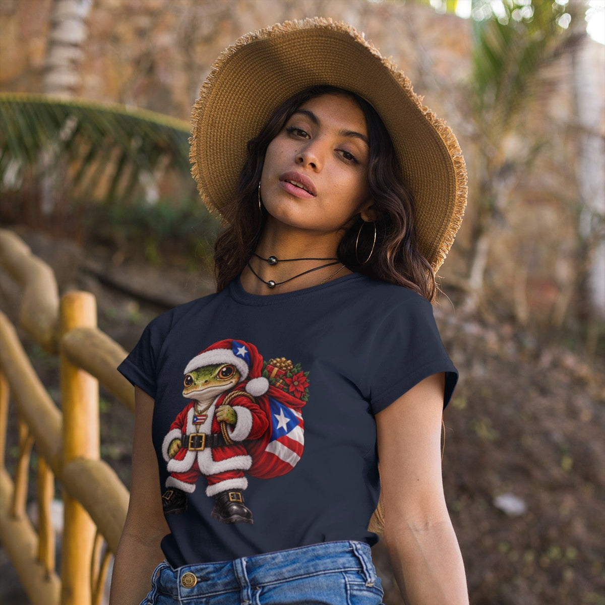Woman wearing a navy Puerto Rican coquí Santa Christmas t-shirt outdoors.